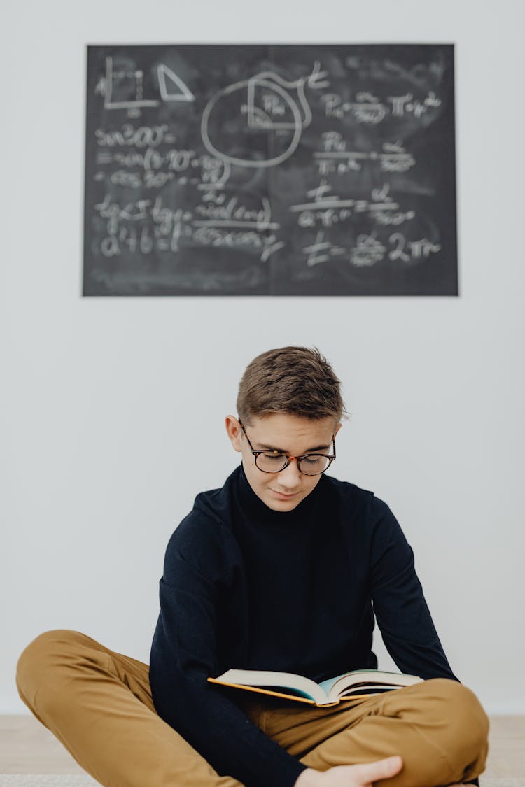 Schoolboy Reading A Textbook