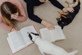 Boy and Girl Reading Books and Playing with Dogs on the Floor