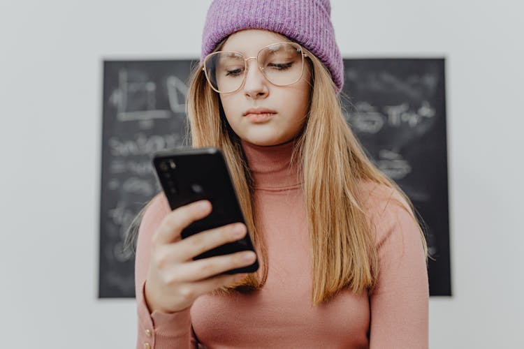 Portrait Of A Teenage Girl Using A Phone