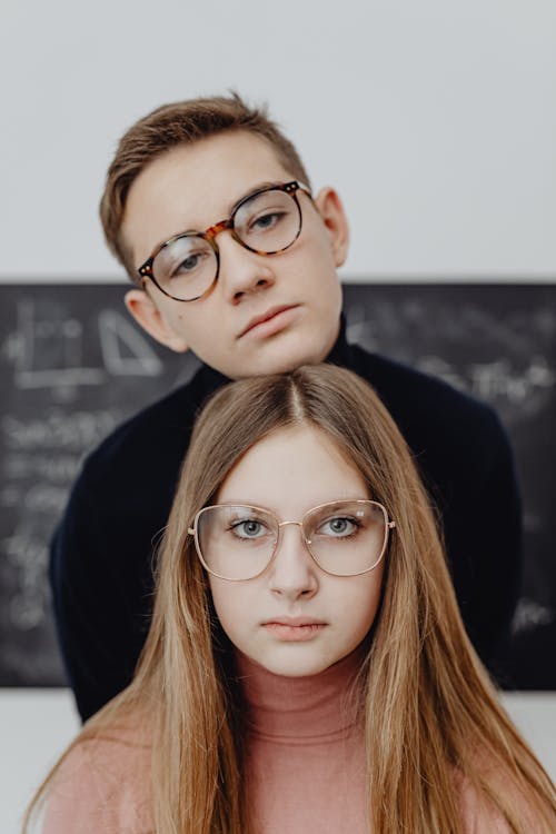 Portrait of a Handsome Boy and a Pretty Girl Wearing Eyeglasses