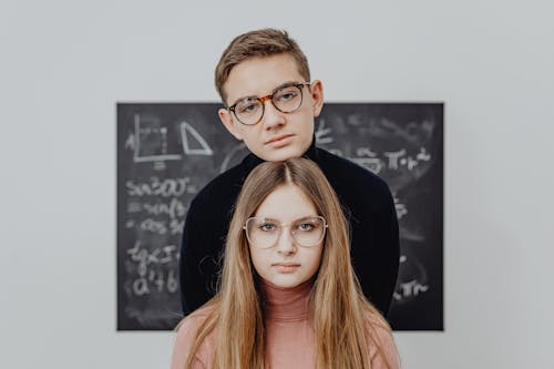 Portrait of a Handsome Boy and a Pretty Girl Wearing Eyeglasses