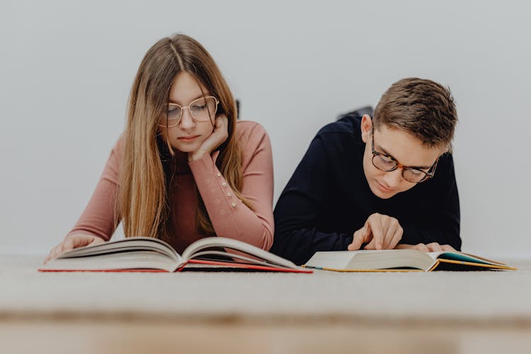 Teenage Boy And Girl Sitting And Learning 