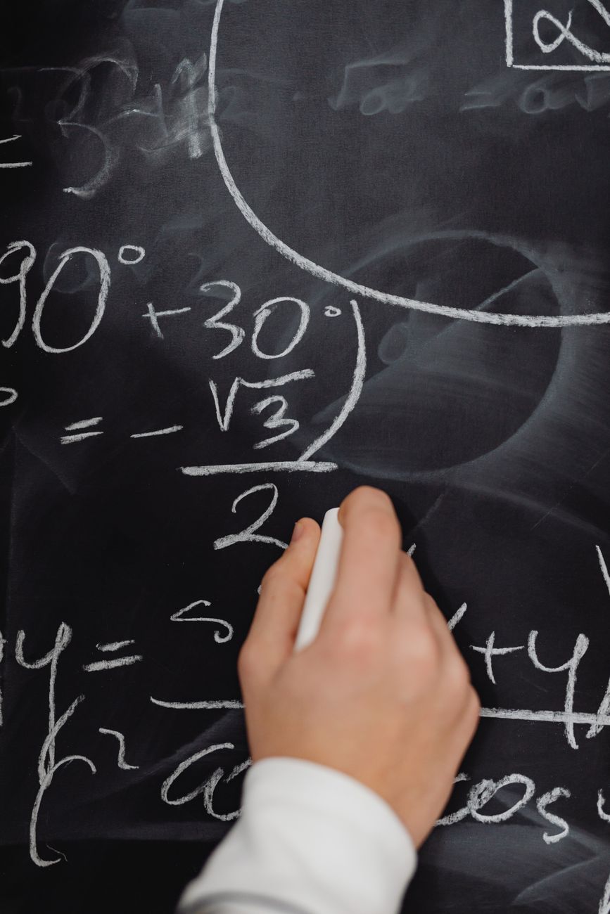 Chalkboard covered in handwritten formulas and equations