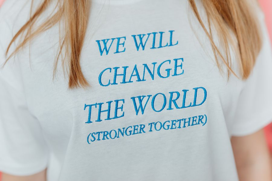 Cream tee with small hand-embroidered name across the chest