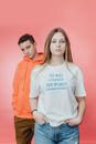 Man in Orange  Hoodie Beside Woman in White T-shirt