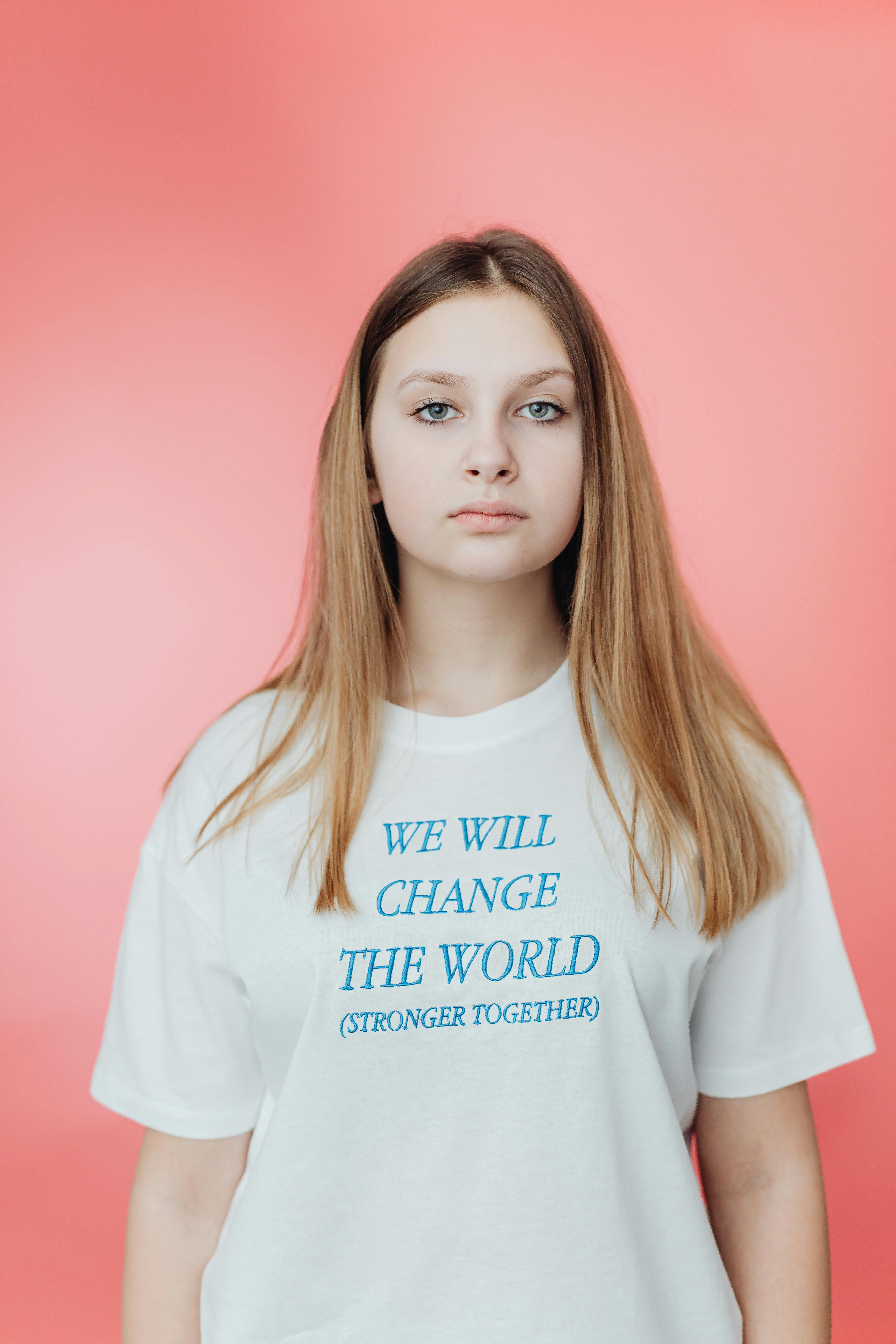 woman in white crew neck t shirt with blue text