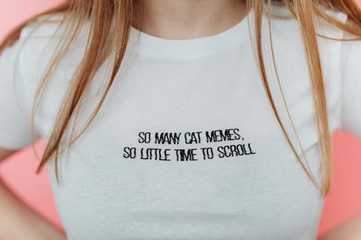 Close-up of a white T-shirt with a humorous cat meme message, ideal for social media enthusiasts.