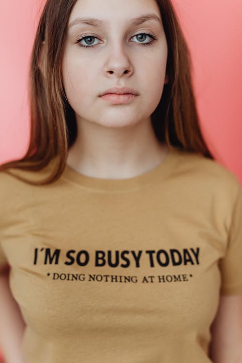 Free A Girl in a Brown Shirt with a Printed Message Stock Photo