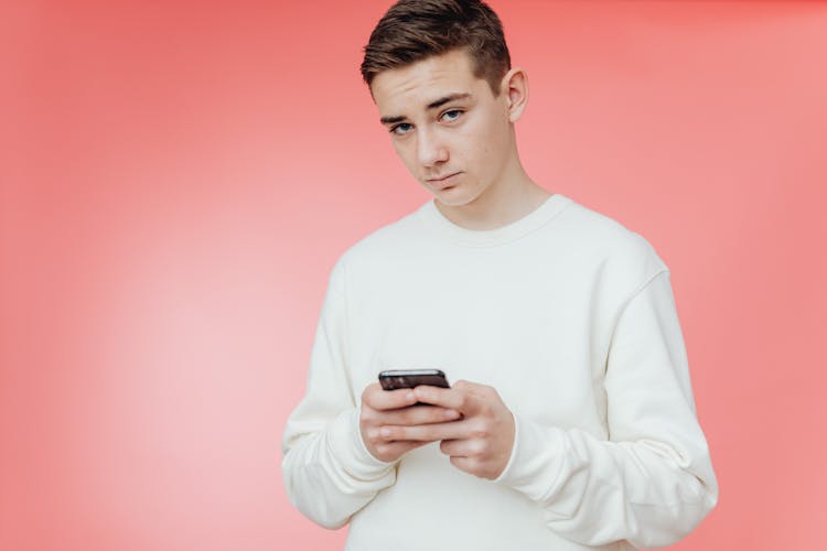 Young Man Holding Smartphone