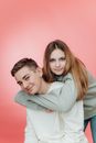 Young Woman in Gray Hoodie Hugging Man in White Long Sleeve Shirt