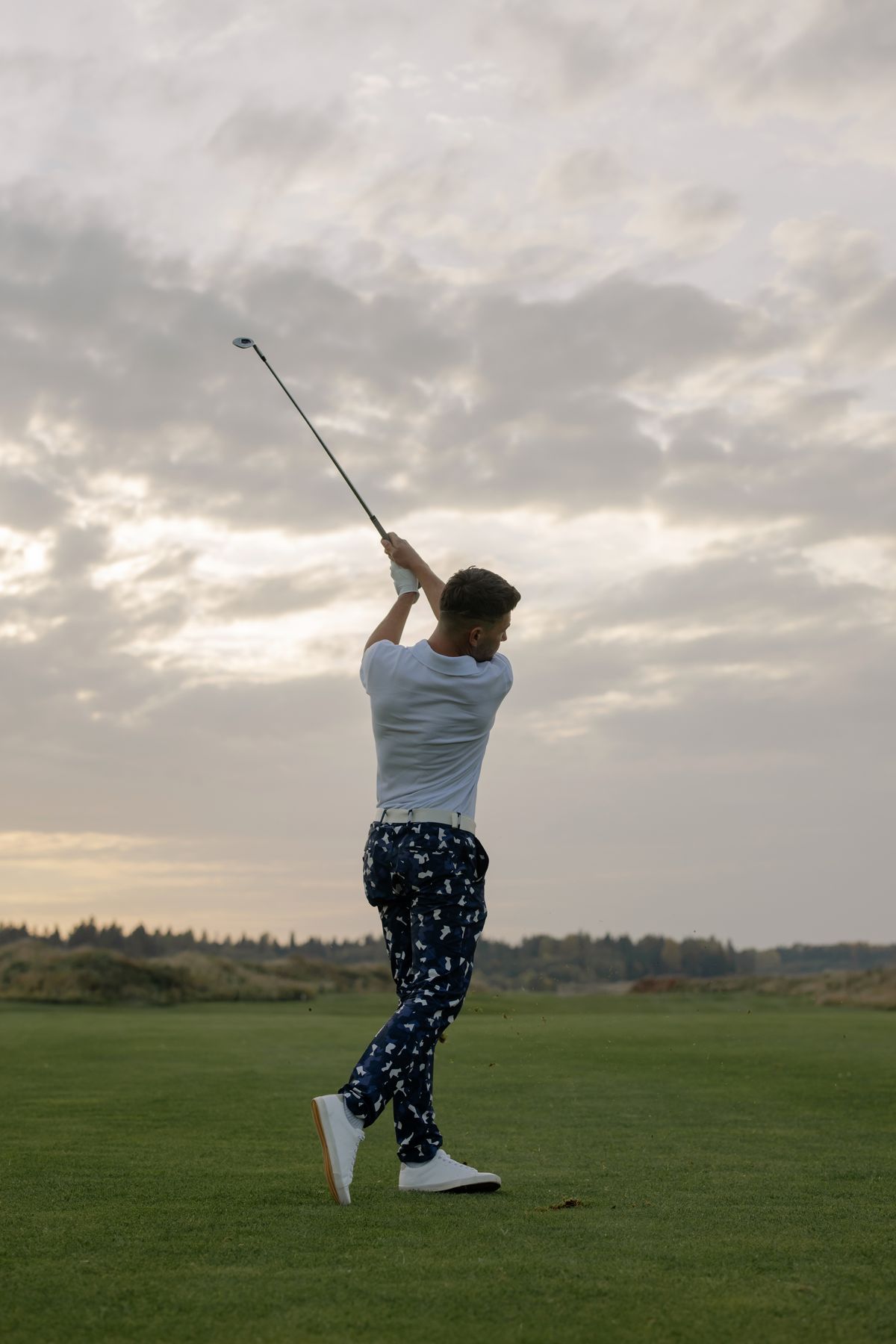 Golfer swinging on the course