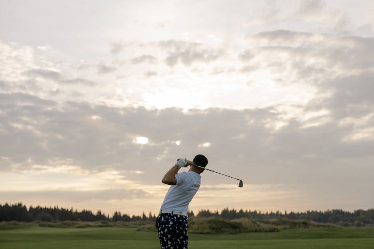 Man In White Polo Shirt Playing Golf