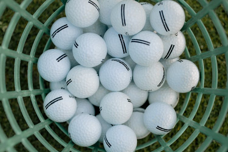 White Golf Balls On A Basket 