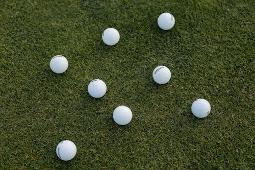 Golf Balls on Green Grass Field
