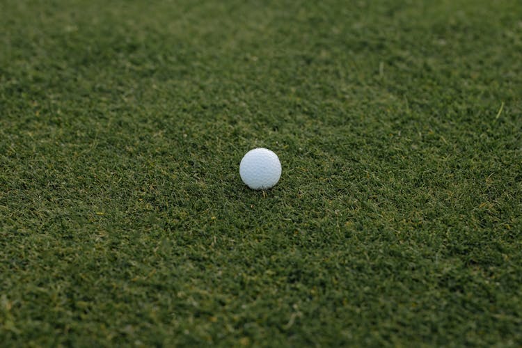 White Golf Ball On Green Grass 