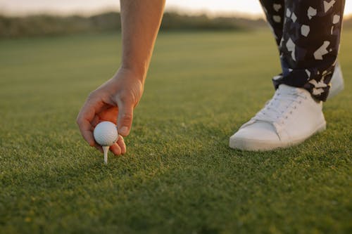 A Man Holding a Golf Ball