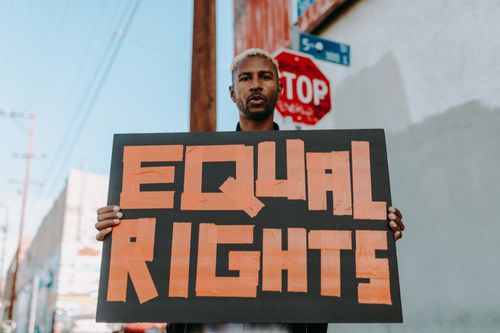Free A person holding an 'Equal Rights' sign during a peaceful protest on the street. Stock Photo
