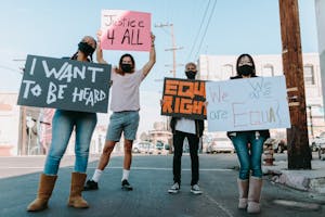 Group of People Standing on the Street Holding Placards