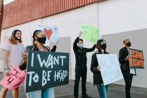 Free A diverse group of people rallying for equality, holding signs advocating for freedom and equal rights. Stock Photo