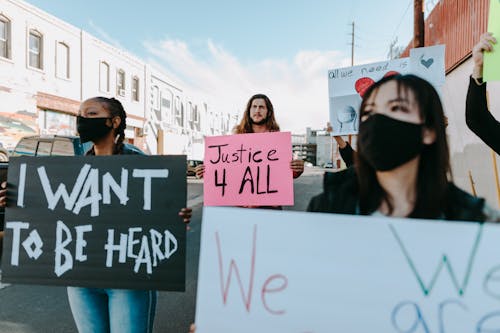 Free People Walking on the Street while Holding Placards Stock Photo