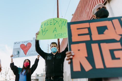 Free Activists holding signs for freedom and equality during a peaceful protest. Stock Photo