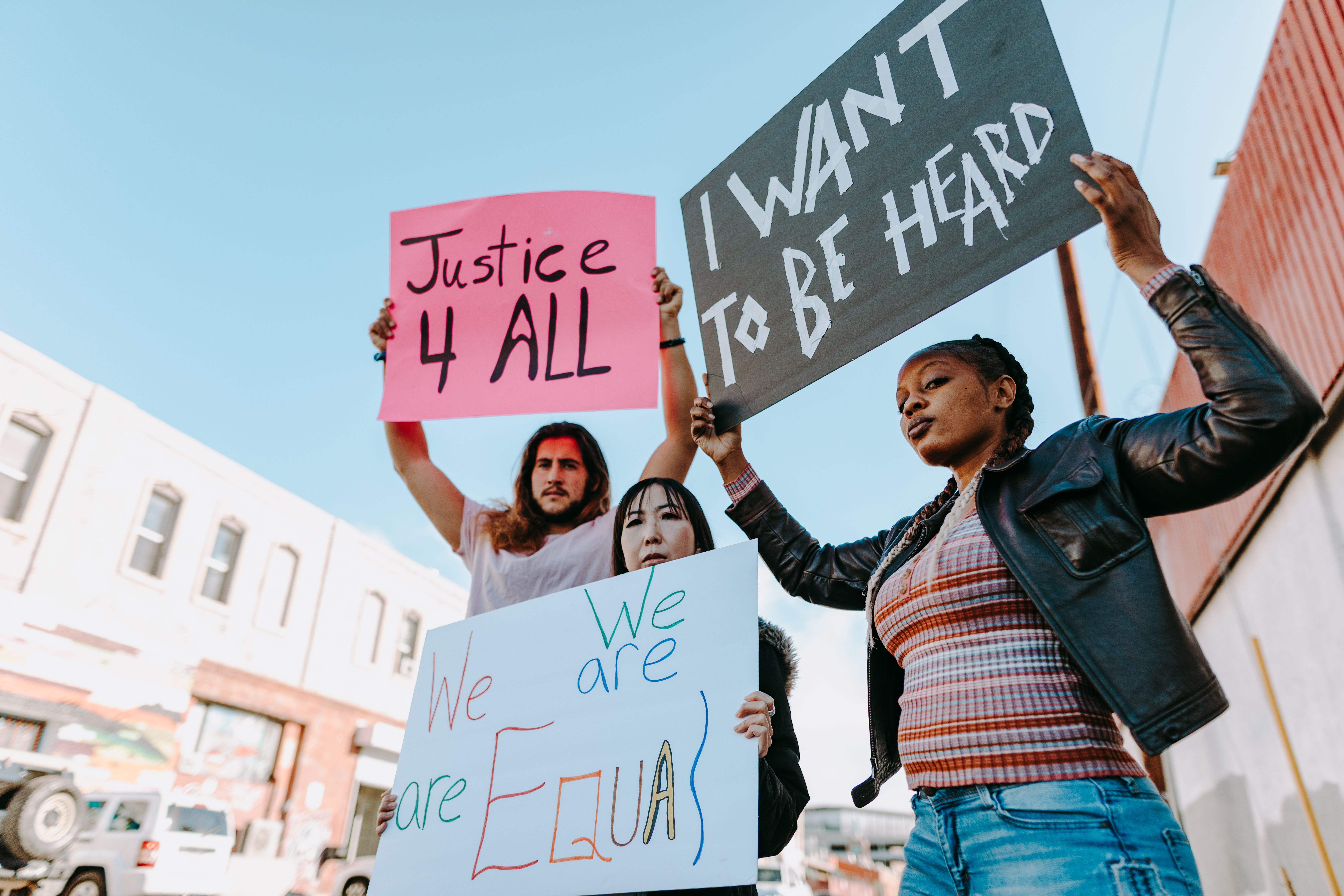 Photo of a Man Raising a Human Rights Signage · Free Stock Photo