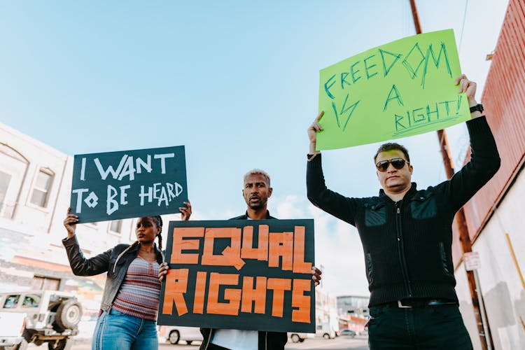 A People Protesting While Holding Banner