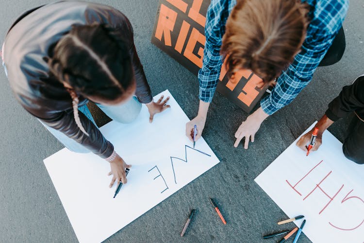 A People Writing On A Poster