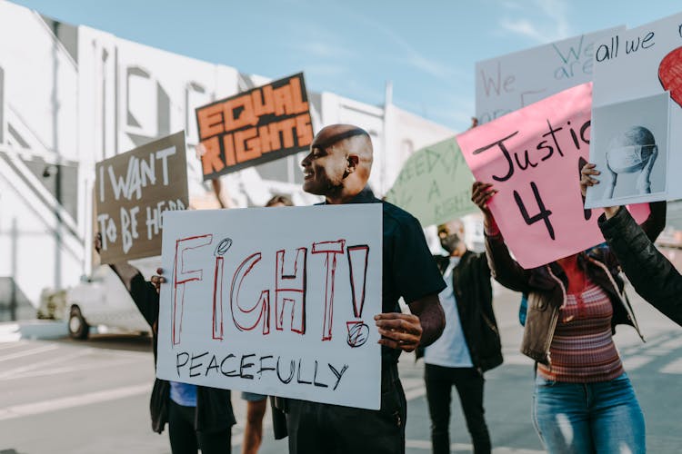 Man At A Protest Holding A Placard