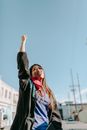 Woman in Black Jacket Standing and Raising Her Right Hand