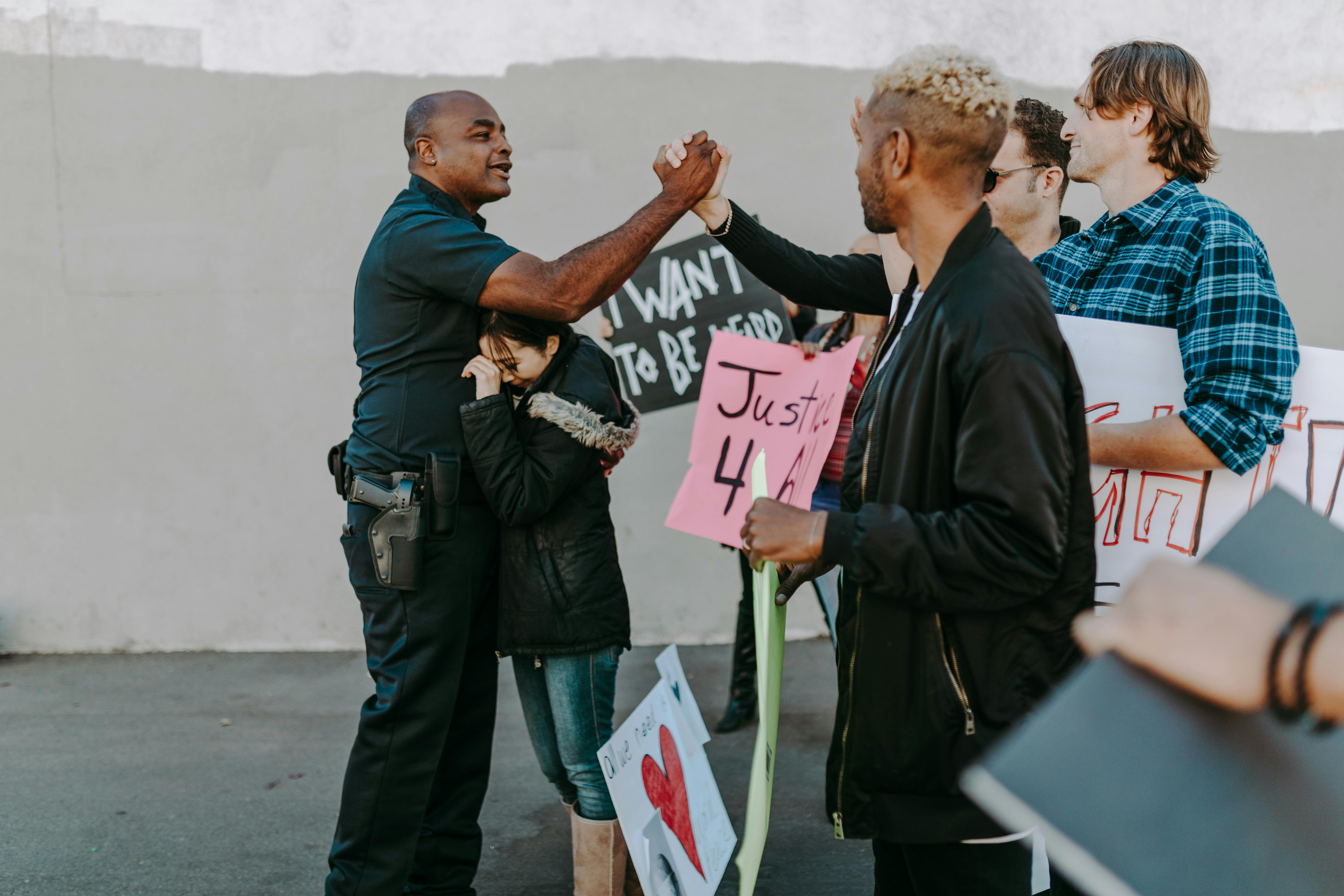 A Policeman Doing Handshake with Protesters