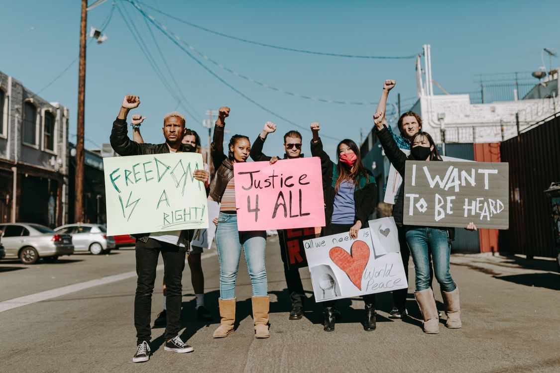 A People Holding Placard Protesting Together · Free Stock Photo