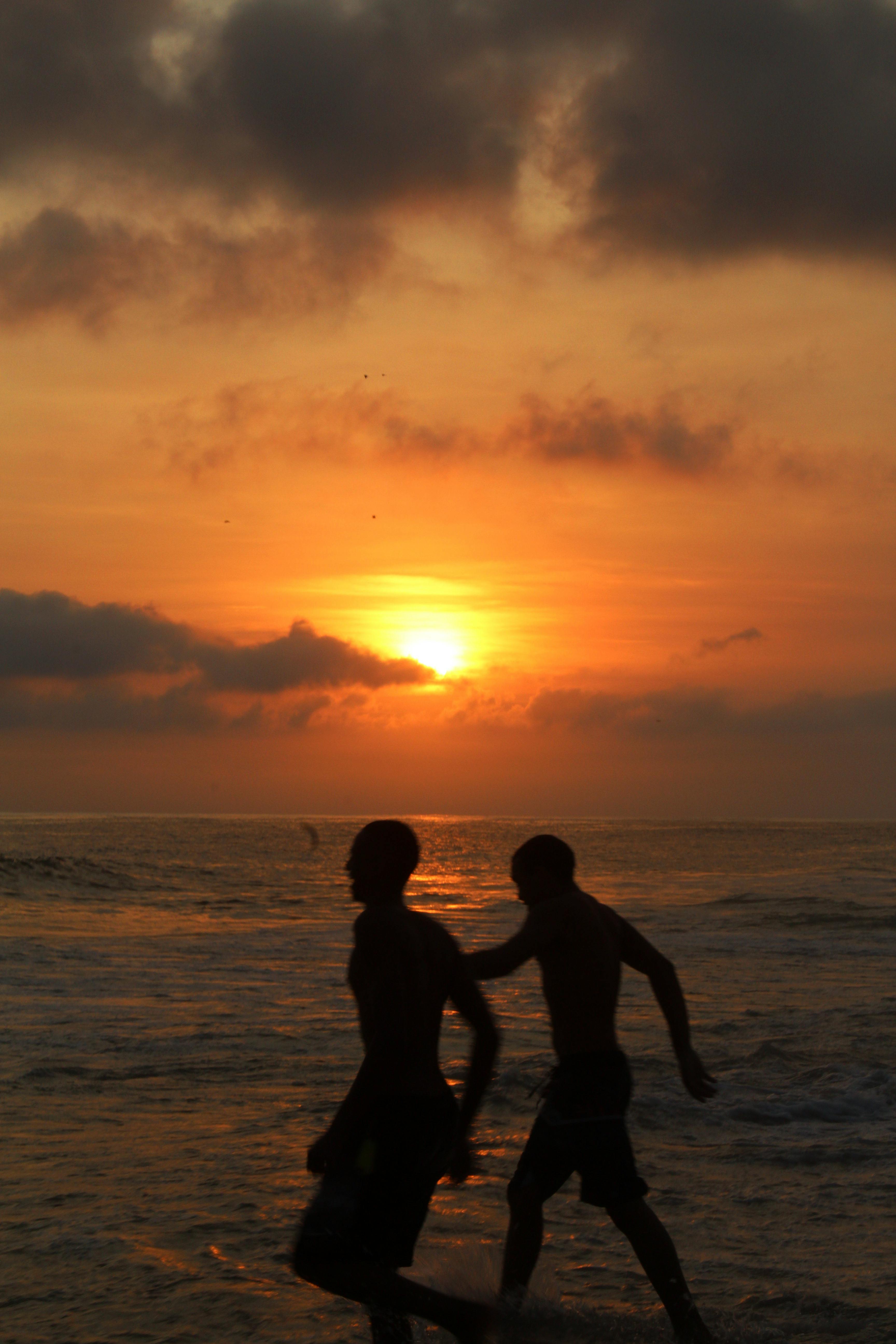 Two Men on a Beach during Sunset · Free Stock Photo