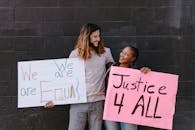 A Man and Woman Holding Protest Banners
