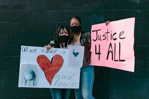 Multiracial women with banners on street