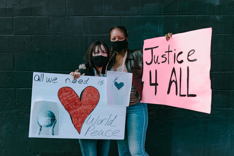 Multiracial Women With Banners On Street