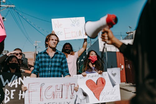 People Holding Protest Banners