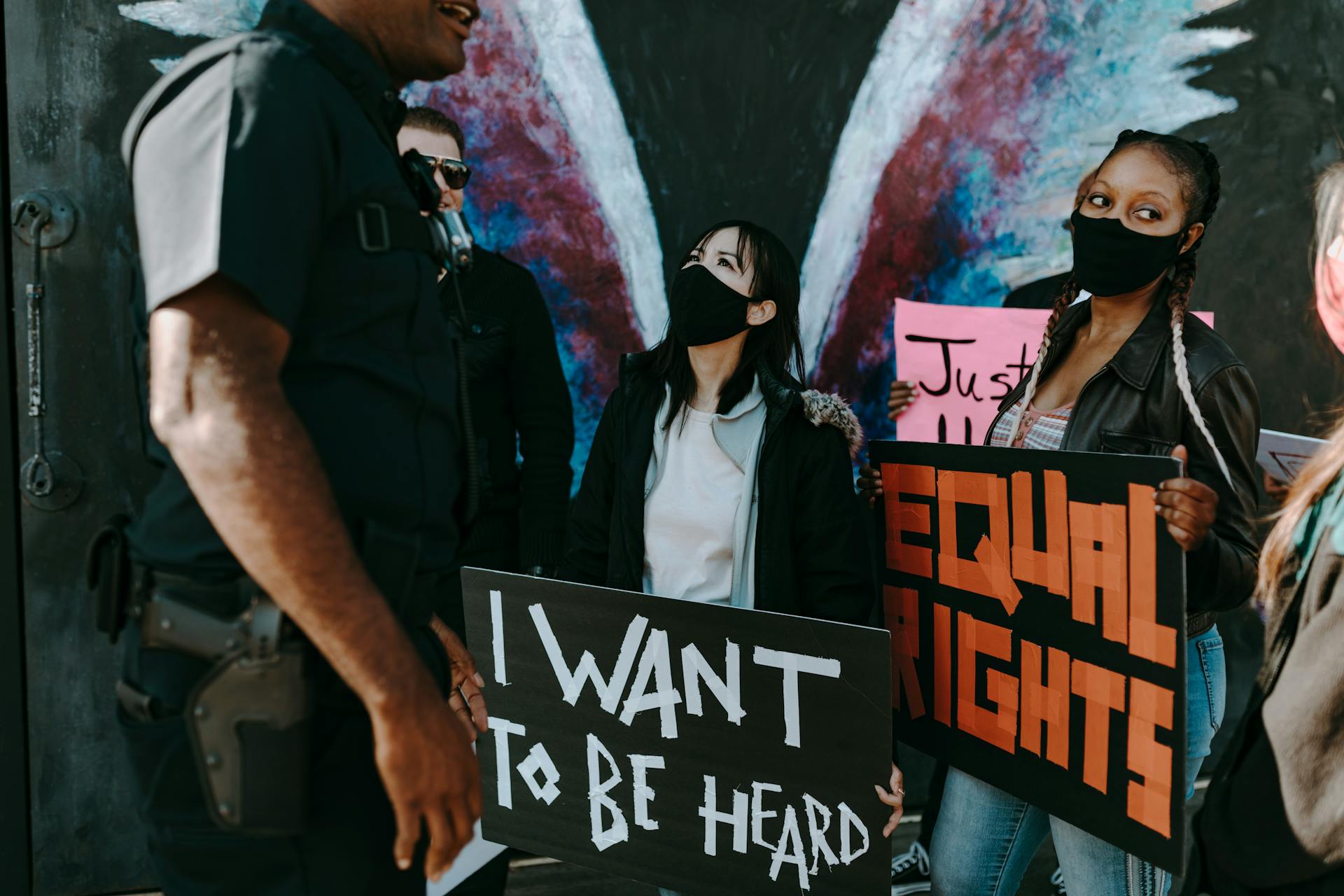 Two Women Holding Protest Banners