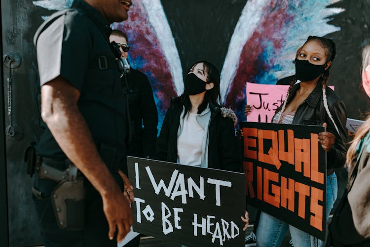 Two Women Holding Protest Banners