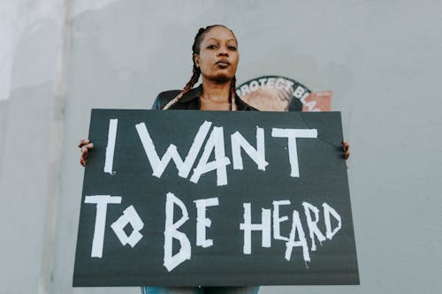 A Low Angle Shot of a Woman Holding a Placard