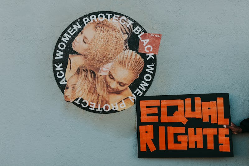 A mural advocating for black women's rights alongside a bold 'Equal Rights' sign.