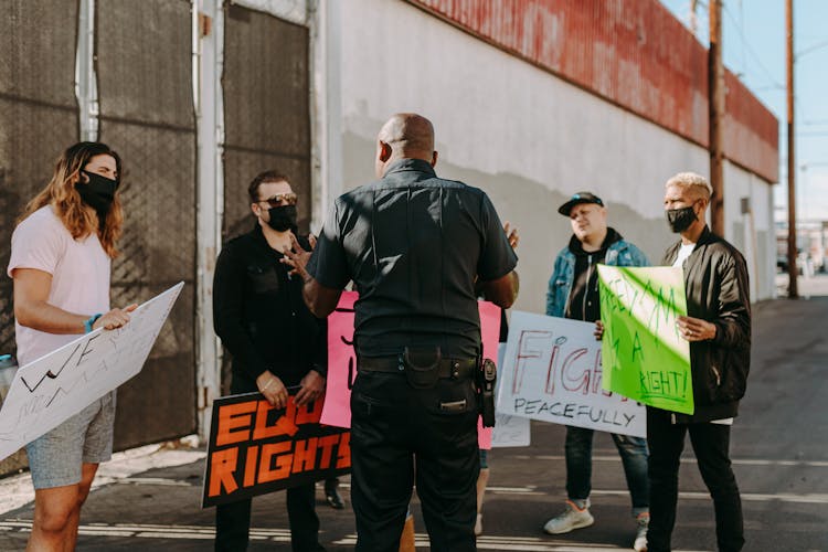 A Police Officer Talking To The Protesters