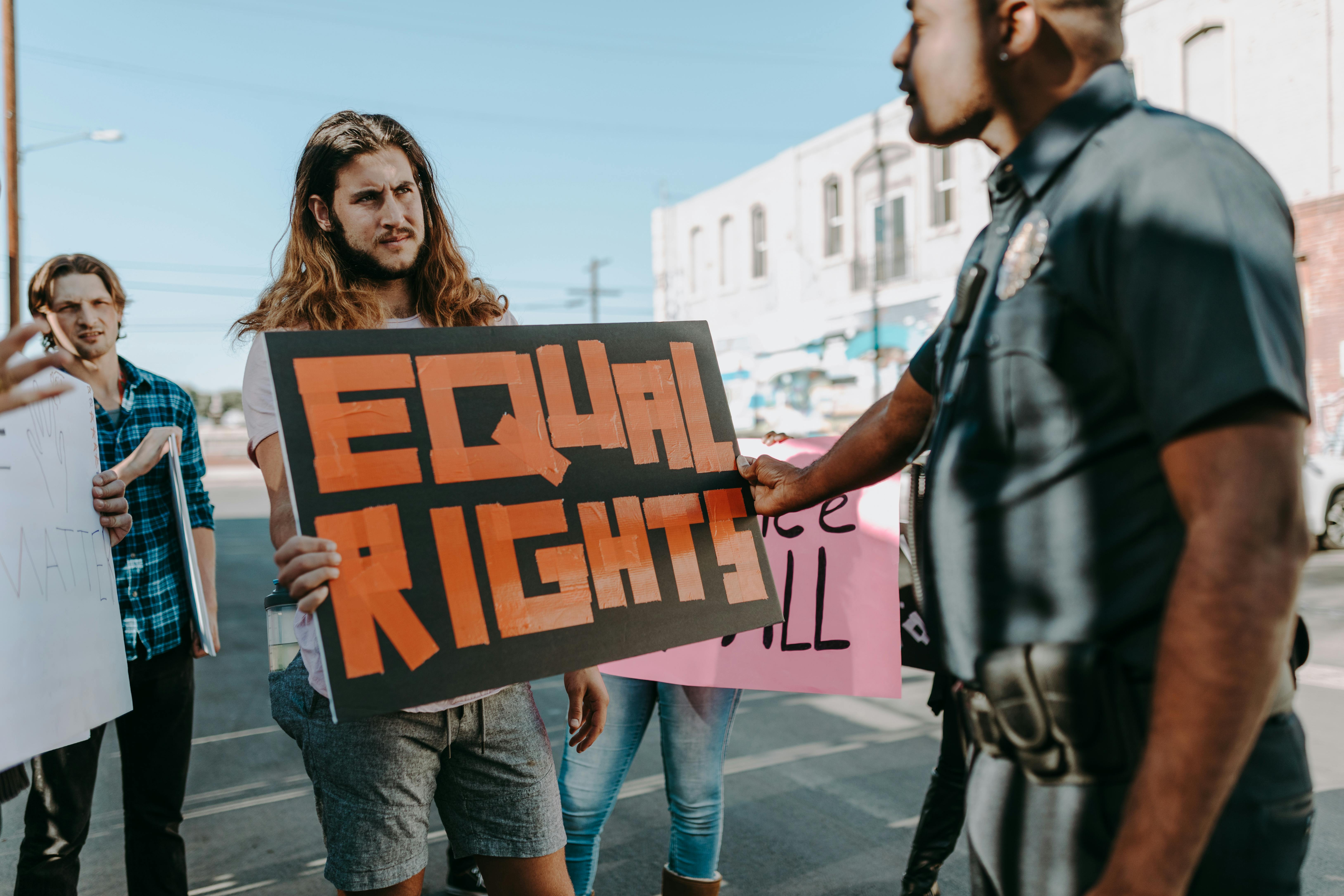 man and woman holding brown and black i am a love you sign