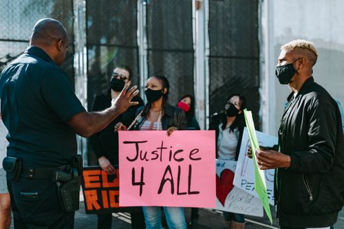 Free A diverse group holds signs advocating justice during a nonviolent protest. Stock Photo