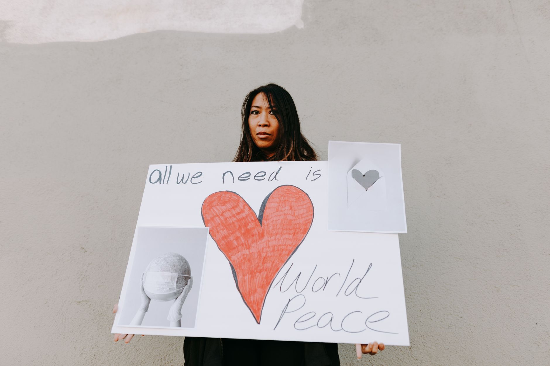 A woman holding a sign advocating for world peace during a protest.