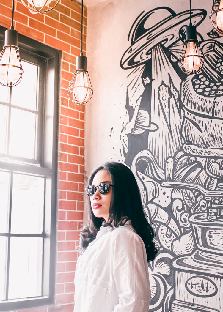 Woman Posing By Mural In Building