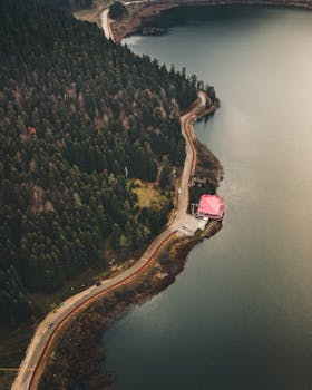 Aerial view of a winding road through forested landscape by Bolu Lake, Turkey.
