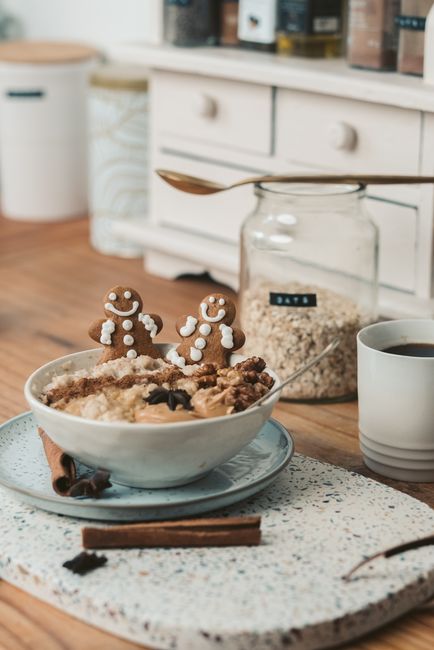 A bowl of thick, chewy steel-cut oatmeal topped with chopped walnuts, a dusting of cinnamon, and a few fresh raspberries, steam rising from the bowl.