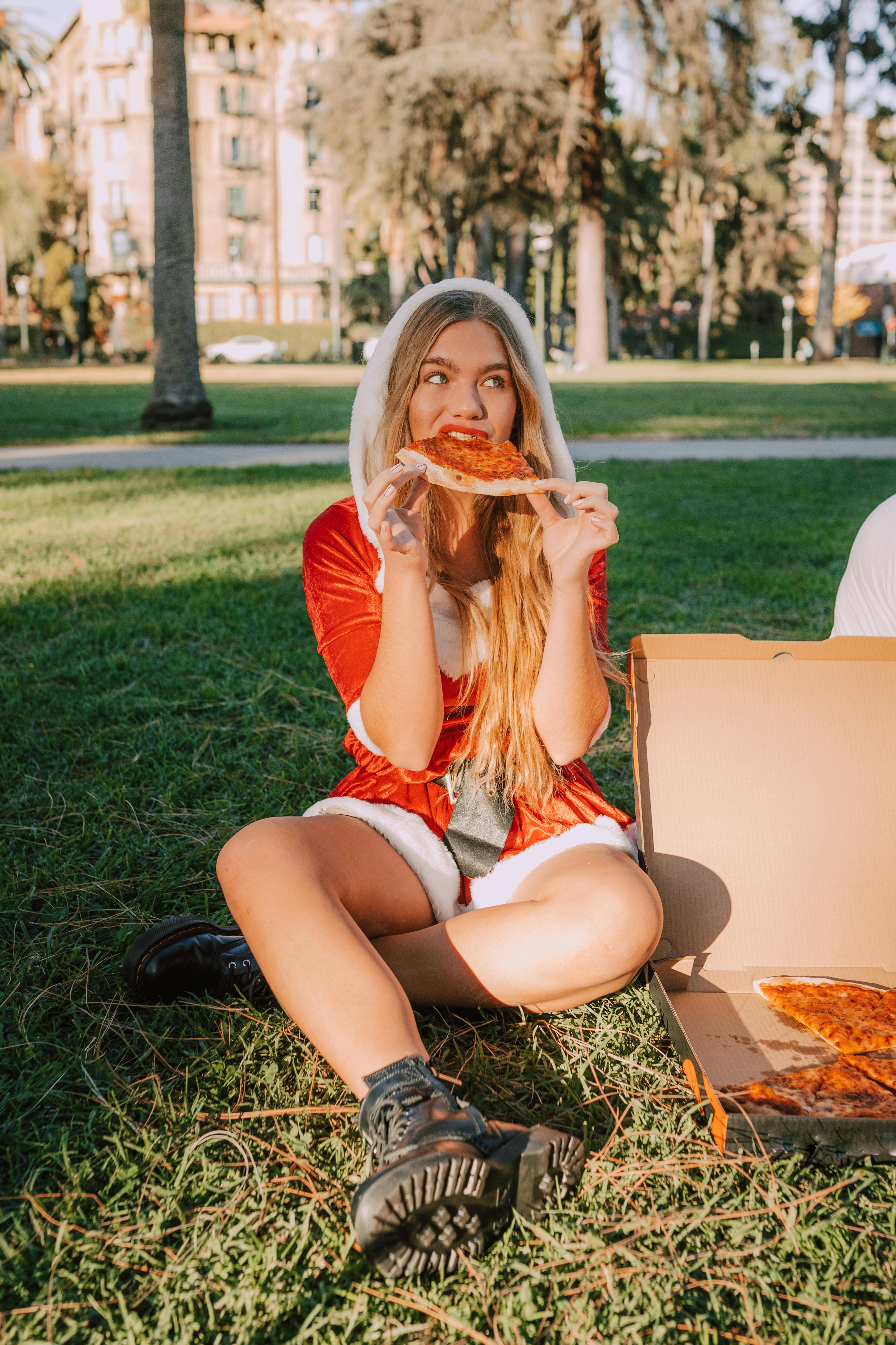 woman in red shirt eating bread