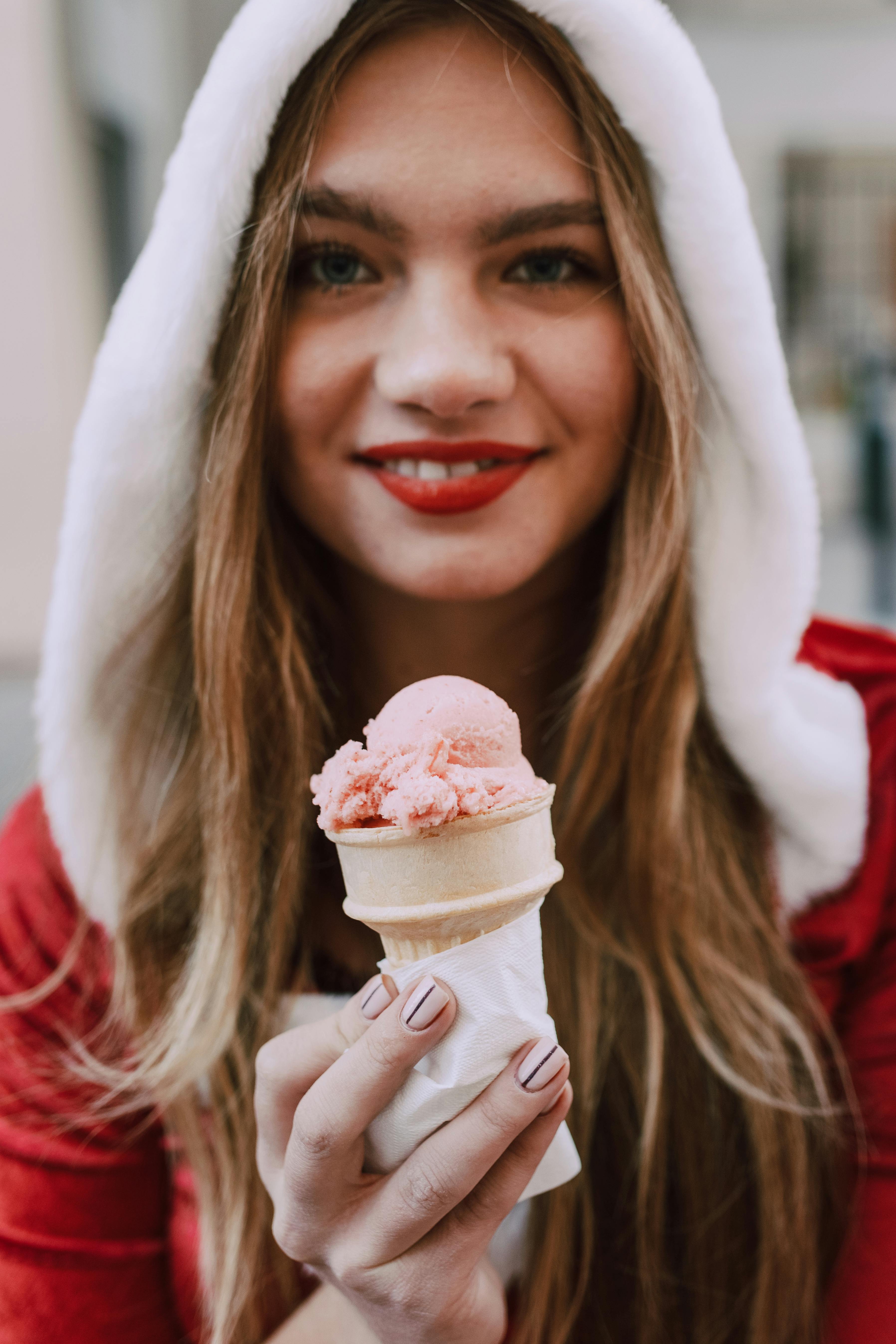 woman in red shirt holding ice cream cone